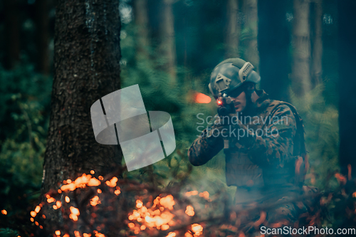 Image of A soldier fights in a warforest area surrounded by fire