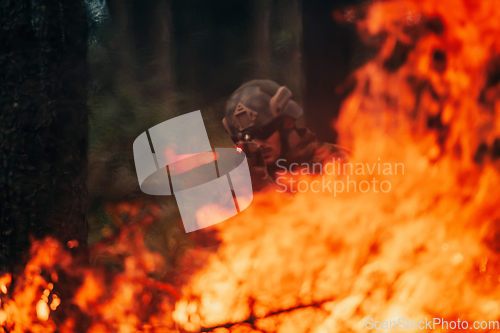 Image of A soldier fights in a warforest area surrounded by fire