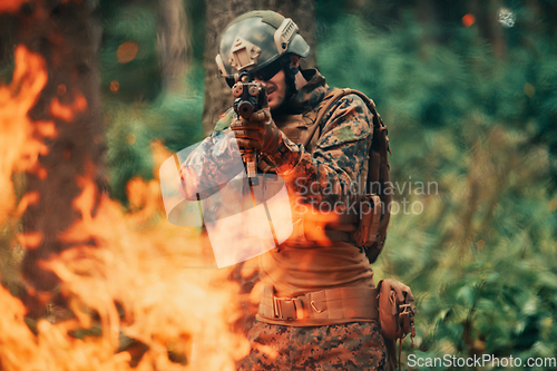 Image of A soldier fights in a warforest area surrounded by fire