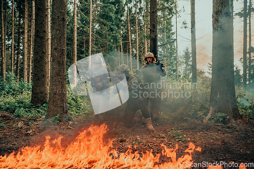 Image of Modern warfare soldiers surrounded by fire fight in dense and dangerous forest areas