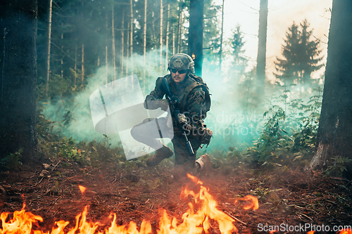 Image of Modern warfare soldier surrounded by fire, fight in dense and dangerous forest areas