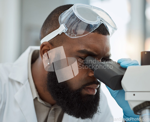 Image of Science, microscope and a man in a laboratory for medical research, study or analysis. Face of a black male person or scientist with a scope for innovation, biotechnology and future development