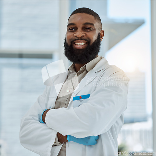 Image of Black man, doctor and portrait with arms crossed in hospital for healthcare services, surgery and consulting in Nigeria. Happy surgeon, therapist and medical professional working with trust in clinic