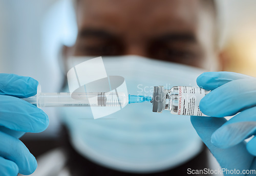 Image of Medicine, vaccine and a doctor man with a syringe and mask for virus, health care and cure in hospital. Hands of person with a pharmaceutical product, vial or container for treatment or injection
