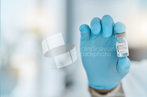 Image of Vaccine, medicine and hand of a doctor with gloves for virus protection, health care and cure in hospital. Person with a pharmaceutical product, vial or container for treatment or prevention space