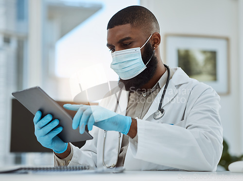 Image of Doctor, black man and tablet in office for medical review, data research or healthcare app. Hospital physician with face mask planning on digital technology for telehealth, consulting and information