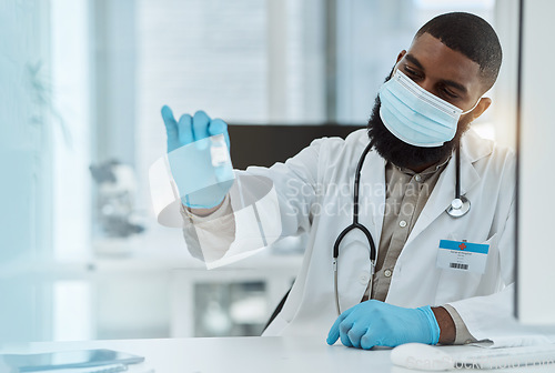 Image of Medicine, vaccine and a doctor man with a mask for virus protection, health care and cure in hospital. Black person with a pharmaceutical product, vial or container for covid treatment or prevention