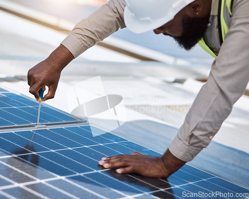 Image of Black man, engineer and repair for solar panel, roof or maintenance for industry, thinking and building. Technician, screwdriver or tools for photovoltaic tech, helmet or sustainable renewable energy