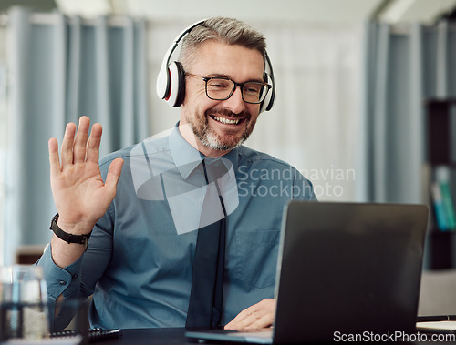 Image of Headphones, laptop and man wave on video call for business, smile and online chat at home. Happy, hello and webinar of mature manager with glasses in virtual meeting, communication and remote work