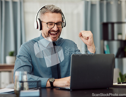 Image of Celebrate, headphones and businessman working on a laptop with good news or achievement. Happy, excited and mature professional male designer in celebration for job promotion or success in workplace.