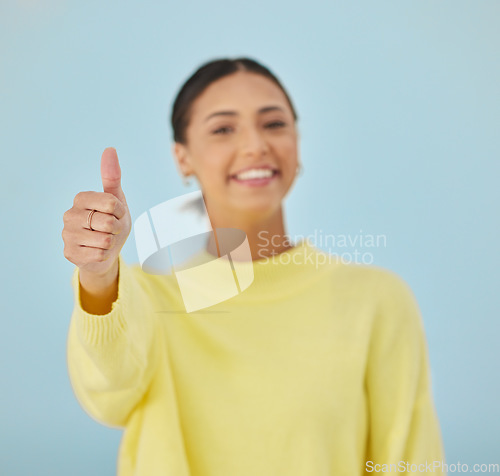 Image of Happy woman, portrait and thumbs up for good job, approval or winning against a studio background. Female person smile with like emoji, yes sign or OK for agreement, thank you or positive feedback