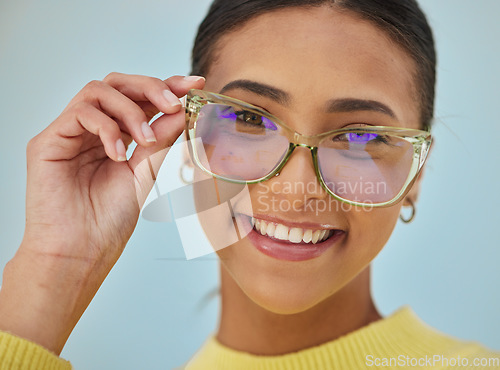 Image of Woman portrait, glasses and vision with blue light frame with a smile with ophthalmology. Isolated, studio background and happy person with eye care, wellness and health of a girl with eyewear