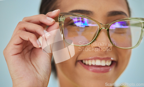 Image of Woman, glasses and vision with blue light frame with a smile with ophthalmology. Isolated, studio background and happy person with eye care, wellness and health of a girl with eyewear and healthcare