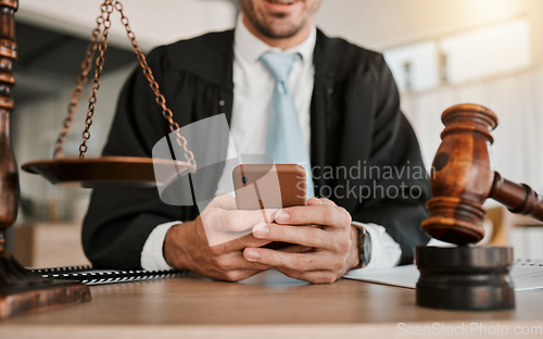 Image of Judge, hands and professional man typing communication, networking or texting legal contact, law firm consultant or advocate. Government lawyer, smartphone and person reading attorney policy update