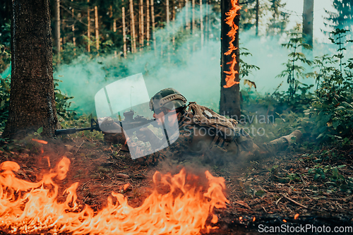 Image of Modern warfare soldier surrounded by fire, fight in dense and dangerous forest areas