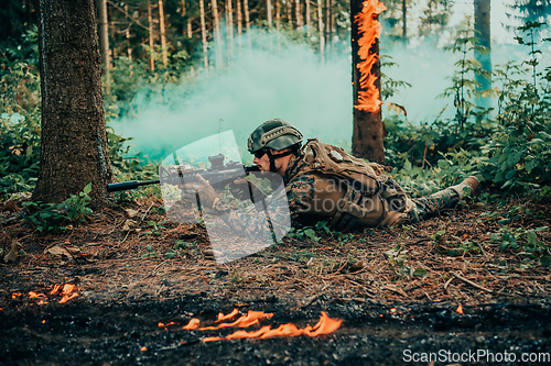 Image of Modern warfare soldier surrounded by fire, fight in dense and dangerous forest areas