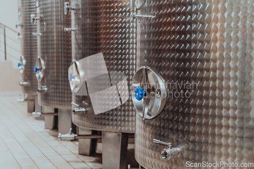 Image of Modern wine distillery and brewery with brew kettles pipes and stainless steel tanks