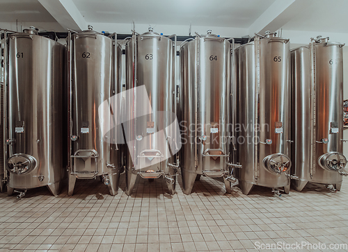 Image of Modern wine distillery and brewery with brew kettles pipes and stainless steel tanks