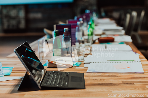 Image of A laptop on the table of a large seminar hall