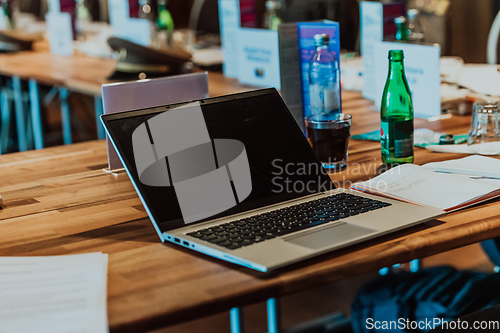 Image of A laptop on the table of a large seminar hall