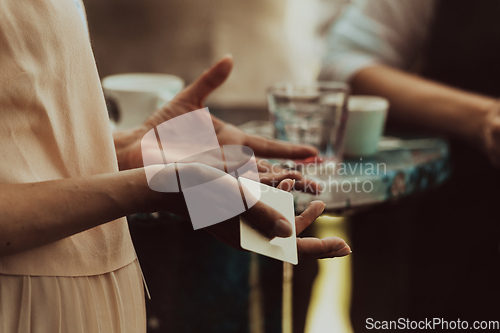 Image of Close-up photo of female hand gesturing while talking to business partner