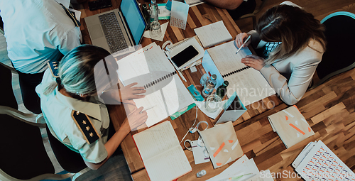 Image of Top view of colleagues sorting out paperwork together. Businessman working with documentation