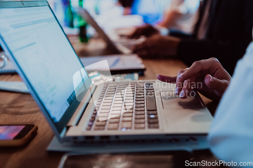 Image of Close up photo of a woman's hand using on a laptop at a seminar