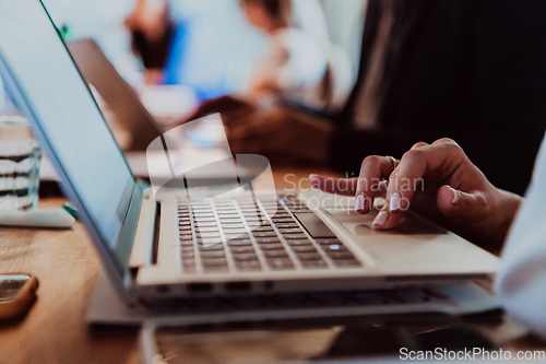 Image of Close up photo of a woman's hand using on a laptop at a seminar