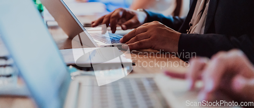 Image of Close up photo of a woman's hand using on a laptop at a seminar