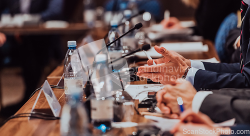 Image of Closeup shot of business people hands using pen while taking notes on education training during business seminar at modern conference room