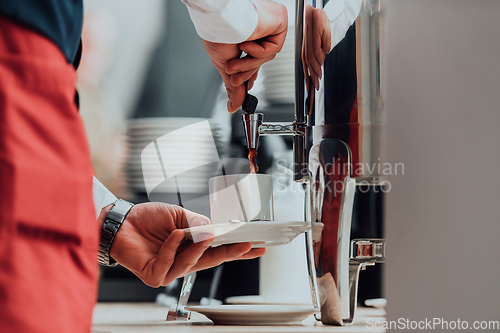 Image of The waiter preparing coffee for hotel guests. Close up photo of service in modern hotels