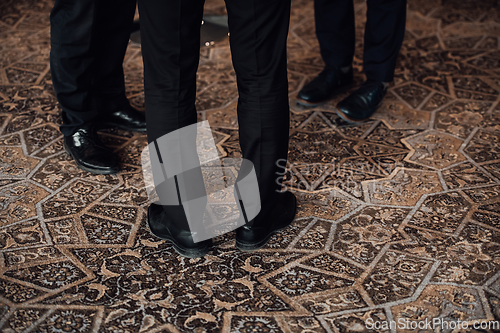 Image of Close up photo of male businessmen in suits talking