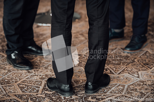 Image of Close up photo of male businessmen in suits talking