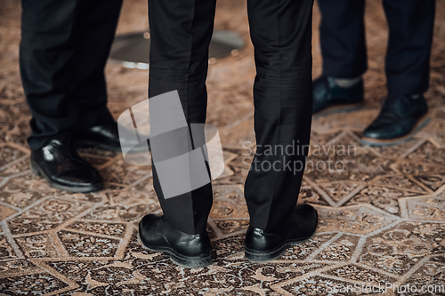 Image of Close up photo of male businessmen in suits talking