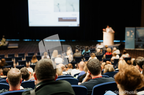 Image of Speaker giving a talk on scientific conference. Audience at the conference hall. Business and Entrepreneurship concept.