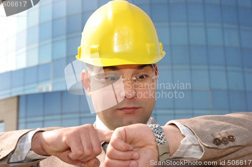 Image of businessman looking at his watch