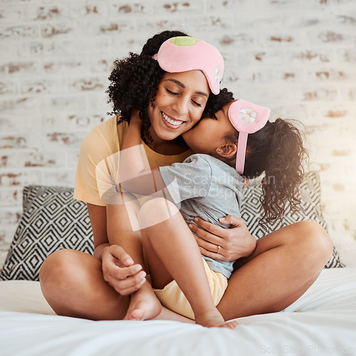 Image of Love, kiss and mother with child on bed for bonding, quality time and affection in morning. Family home, happiness and mom embrace daughter after sleeping, dreaming and relax in bedroom together