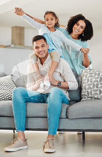 Image of Portrait, smile and family on sofa in home living room, bonding and relax together. Interracial, happy and father, mother and child, girl or kid in piggyback, play game and quality time in house.