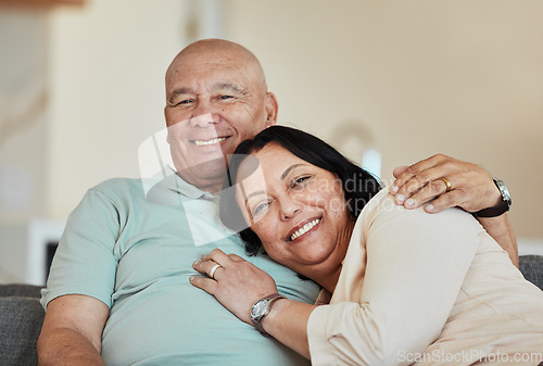 Image of Portrait, smile and senior couple in home living room, bonding and relax together. Face, happy and elderly man and woman hug on sofa in lounge, enjoying quality time in house with love and retirement