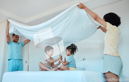 Image of Children, play and family with blanket in bedroom, bonding and smile together. Interracial, kids game and father and mother at bed with sheet for patty cake, happy and enjoying quality time in house