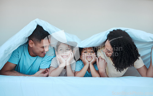 Image of Blanket, family and parents with children in bed for bonding, quality time and affection in morning. Happy, love and portrait of mother, father and kids in bedroom for fun, playing and relax at home