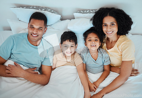 Image of Top view, bed and portrait of parents with children for bonding, quality time and affection in morning. Happy, family and above of mother, father and kids in bedroom for fun, sleeping and relaxing