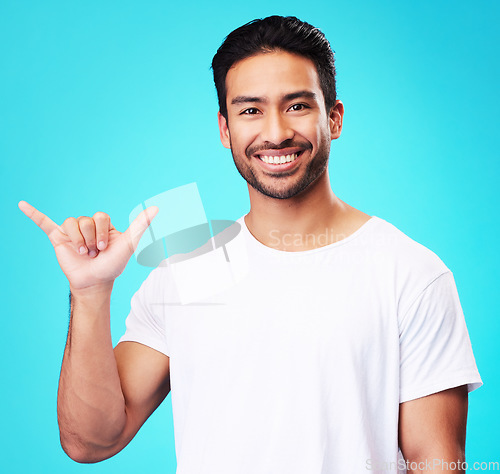 Image of Man, smile and shaka in studio portrait with sign language, icon and youth by blue background. Indian student guy, fashion model and hand for call me, emoji and happy with gesture, symbol or contact