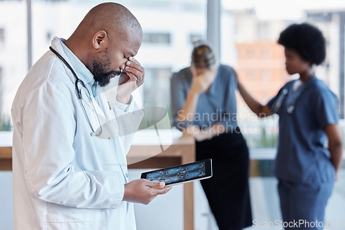 Image of Surgeon, man and medical error or frustrated at hospital with tablet or bad news for patient. Mistake, doctor and technology with results or scan with error by healthcare worker with crises or xrray.