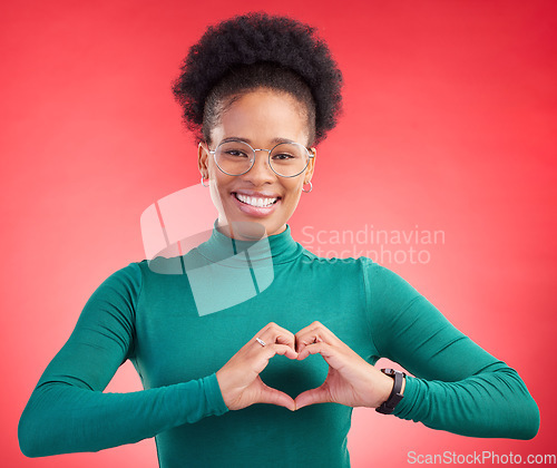 Image of Happy woman, portrait and heart hands for love, care or romance against a red studio background. Female person smile with emoji, symbol or shape for romantic gesture, health support or like on mockup