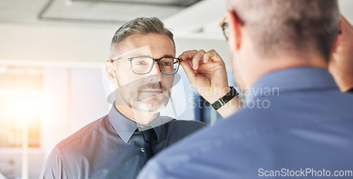 Image of Mirror reflection, optometry and man with glasses for eye care, vision and choice of frame. Mature, store and person eyewear shopping for a lens or fit for eyeglasses style in a shop with a decision