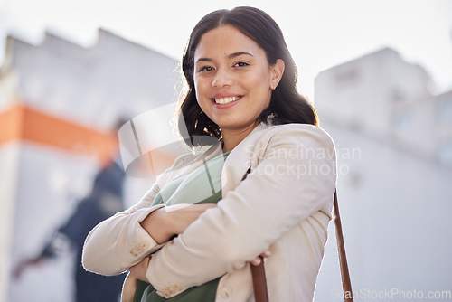 Image of Business woman, arms crossed and portrait outdoor in city with travel and smile. Urban, face and female professional with bag for career and commute to work feeling happy and proud from confidence