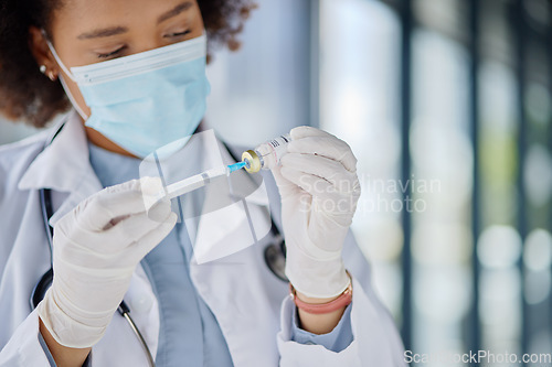 Image of Healthcare, woman or a doctor with a vaccine for a virus or health medicine in a hospital. Face mask, safety and an African nurse or surgeon with a drug vial and syringe for nursing at a clinic