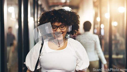 Image of Headphones, happy and face of a woman in the office walking with her colleagues to her desk. Greeting, smile and portrait of a female creative designer listening to music, radio or song in workplace.