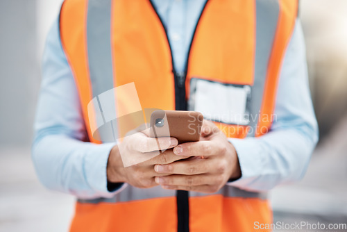 Image of Phone, construction site and search with hands of person for engineering, architecture and communication. Building, social media and mobile app with closeup of contractor for contact and networking